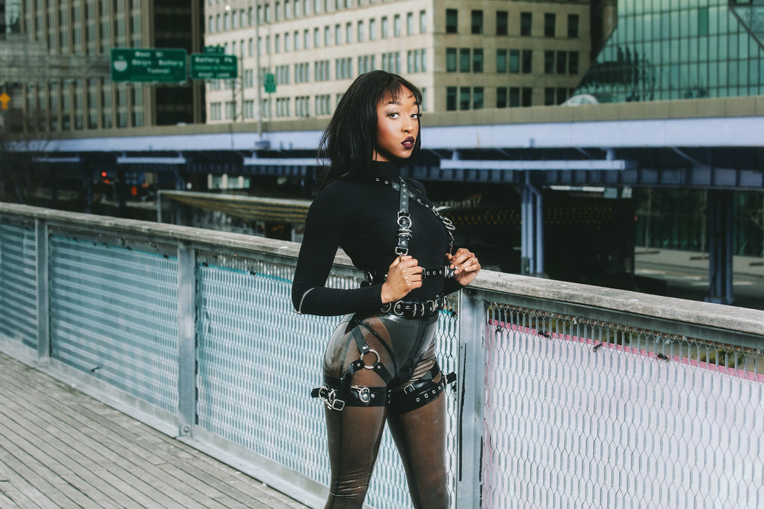 filmmaker jheanelle corine wears transparent latex leggings and latex harness for latex in public photoshoot