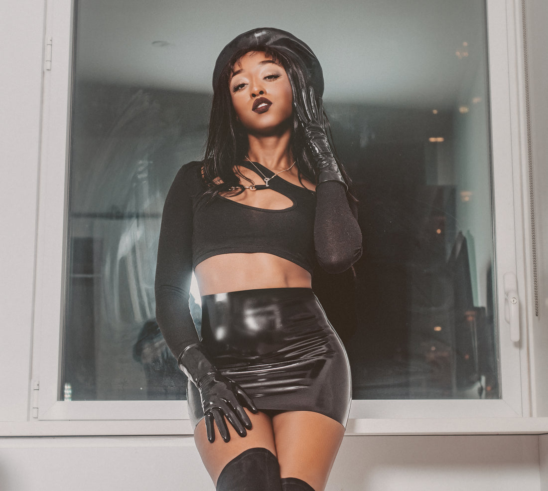 Filmmaker Jheanelle Corine wears latex beret, latex mini skirt, and latex gloves, in one of her sexiest knee high boot latex outfits yet