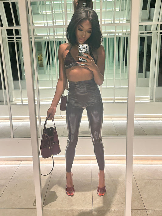 Jheanelle in a sleek and shiny latex two-piece outfit, exuding confident allure