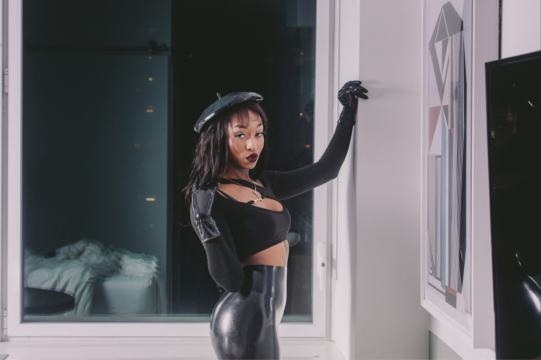 Filmmaker Jheanelle Corine wears latex beret, latex mini skirt, and latex gloves, in one of her sexiest knee high boot latex outfits yet