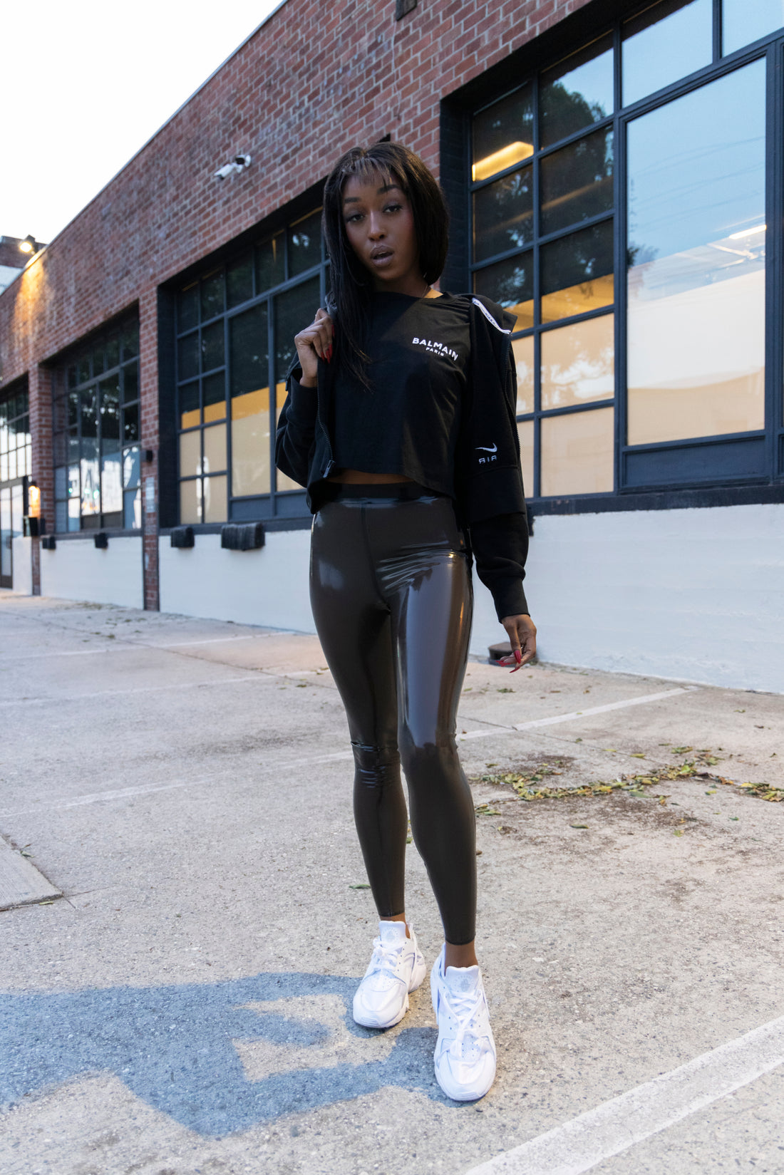 Jheanelle Corine posing in her transparent and black latex leggings in public